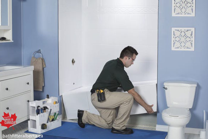 Man placing bathtub in the bathroom